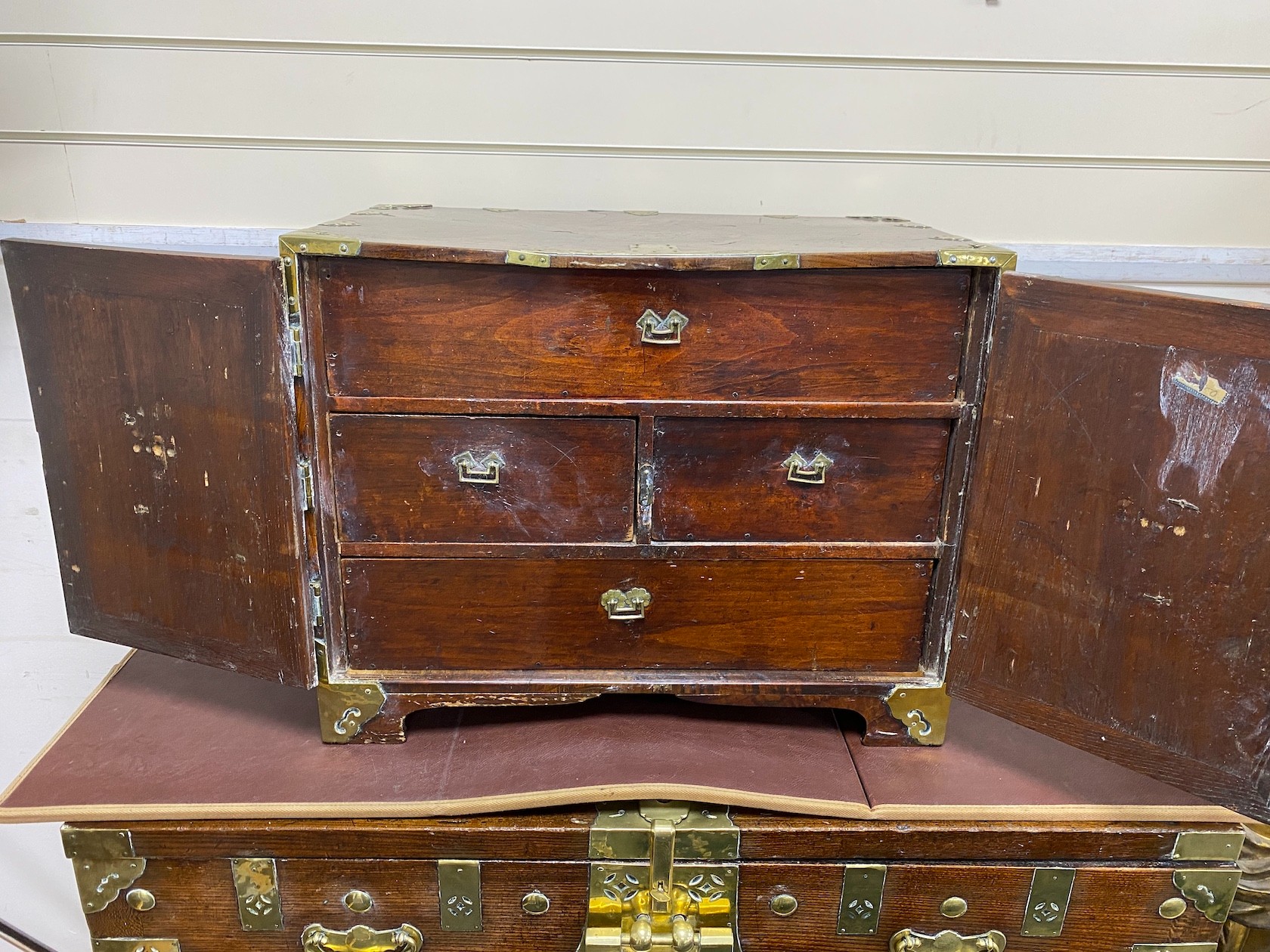 A 19th century Korean brass mounted zelkova bandaji chest and a similar 'safe' cabinet, The larger cabinet height 92cm, width 104cm, depth 52cm deep, the smaller cabinet height 45.5cm, width 59cm, depth 35cm